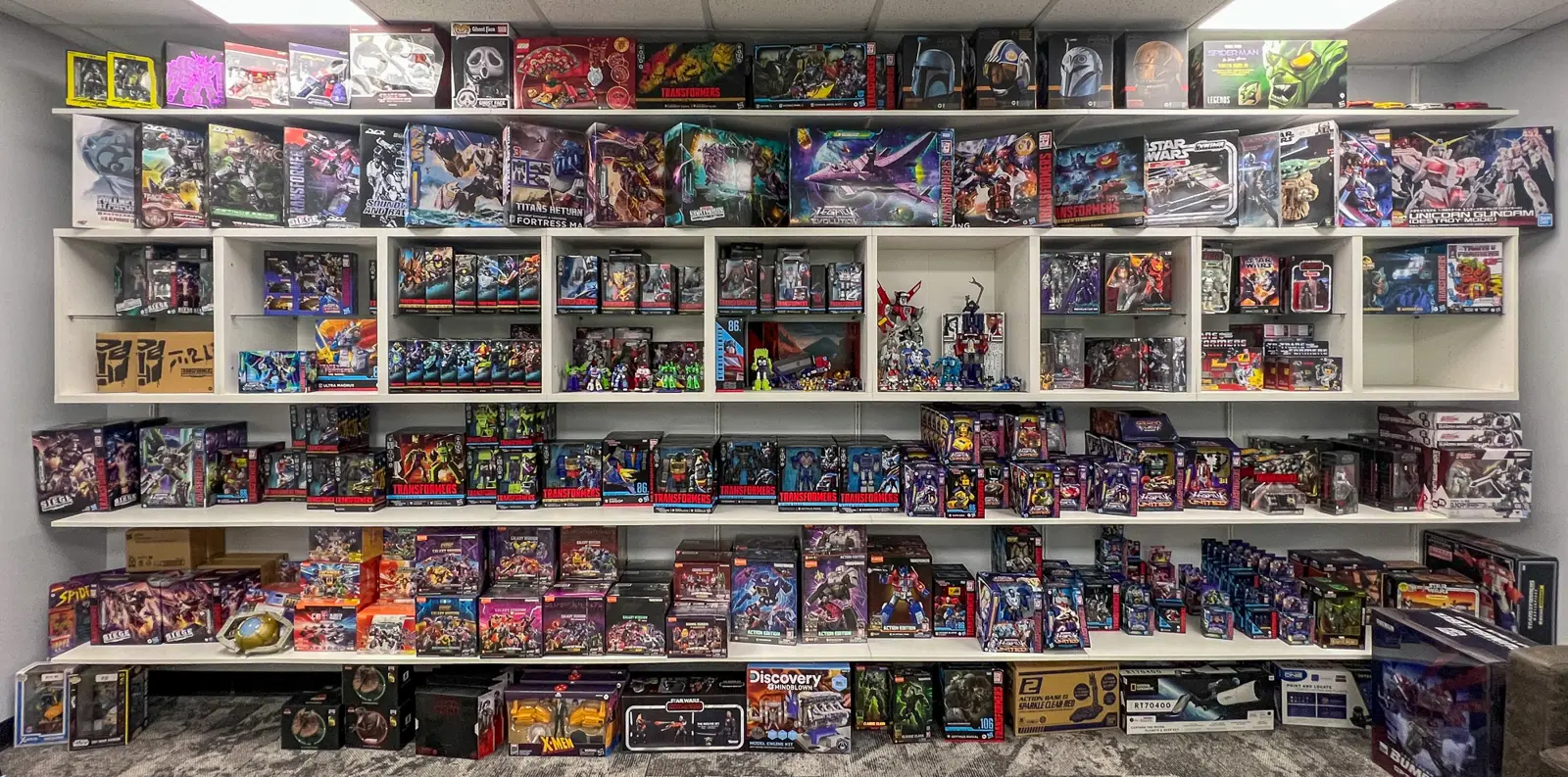 The polaris brothers showroom wall stacked with Transformers, Marvel and Star Wars figures